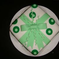 Green Circle Fondant Cake This is an 8"x8" square pan covered in white fondant and then used circle cutters to make an inlayed design.