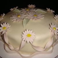 Mini Daisies I created this cake using MMF and gum paste flowers. Any comments are greatly appreciated.