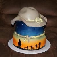 Cowboy Silhouette At Sunset There are 3 different hand painted cowboy silhouettes on this cake.