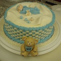 Ben's Baby Shower Cake For a friend, yellow cake with buttercream. The blankie is fondant, the baby and bear and toys are 50/50 gumpaste and fondant.