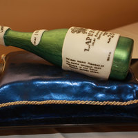 Booze Bottle Groom's Cake The base is a Collete Peters CocoLoco recipe cake with raspberry buttercream, and the bottle is hollow cast white chocolate with a hand...