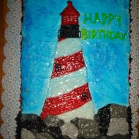 Lighthouse White cake with strawberry filling, I used color gel tube for the lighthouse and black and white frosting for the rocks. I also used Wilton...