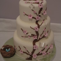Blossoms And Butterflies vanilla cake covered with fondant, gumpaste blossoms, butterflies and robin eggs. birds nest made from RKT covered with butter cream
