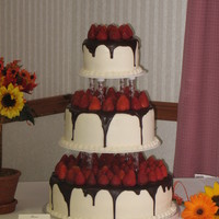 Chocolate And Strawberries covered with buttercream, drizzled with dark chocolate ganache topped with fresh strawberries