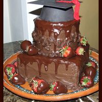 Double Chocolate Grad Cake Chocolate cake with hershey syrup frosting with chocolate glaze.