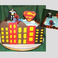 Super Hero Birthday Cake Choc cake with raspberry filling (yum!). BC frosting with chocolate transfer buildings and superman "s." Batman was a toy and...