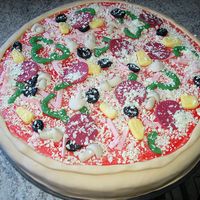 Pizzacake My son wanted a pizzacake yesterday at his 10th birthday, chokolate cake with carameltruffle and raspberrytruffle, and sugarpaste