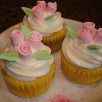 Fondant Rose Cupcakes Buttercream icing with pink fondant roses.