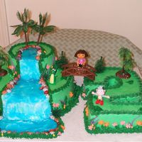 Dora Birthday cake for my Godchild's 2nd birthday. All buttercream with cascade made out of piping gel tinted blue and tropical plastic...