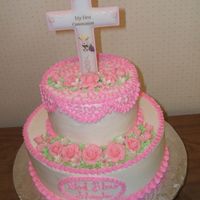 Shayla's First Communion First Communion cake for my niece's first communion. Her mom purchased the cross topper. Buttercream with fondant flowers.