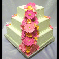 Pink Daisy Wedding Cake This was so fun to do! I made the gumpaste gerbera daisies to match the brides invite. Her colors were pink and orange. All the flowers are...