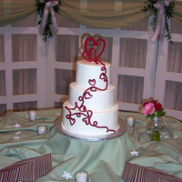 Romantic Wedding Cake This cake was designed to match the wedding invitation. The cake topper and the cascade of hearts and scrolls were made from gumpaste. The...