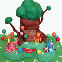 Pooh Bear Cake Cake for my nephew's first birthday! This is Pooh's Tree House with a party going on in front of it. The tree is rice krispies...