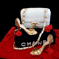 Chanel Cake White almond sour cream cake with chocolate ganache filling. Shoes made out of fondant with tylose added. Everything is edible except for...