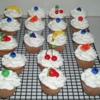 Fruity Cupcakes! Handmade fondant fruit. Blueberries, strawberries, cherries, orange slices, bananas and grapes. Butter cake with raspberry filling.
