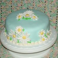 Daisy Cake 8 inch yellow cake covered in fondant. My first attempt at making fondant daisies.