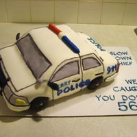 Policecar1 This is my first all-fondant cake. It is made of 3 9x13 layers and then a 9x9 layer on top.