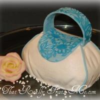 Mini Purse Cake Purse carved from a 6" round. The white "fabric" is buttercream. The blue accents are fondant.