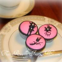 Pink And Black Minis Mini cupcakes decorated with pink and black fondant. TFL