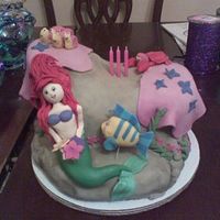 Ariel Cake The Ariel cake is one of my earlier cakes. The rock is cake and the decorations are all fondant.