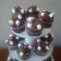 Rocky Road Chocolate cake with chocolate buttercream, topped with marshmallows, chocolate chips and pecans.