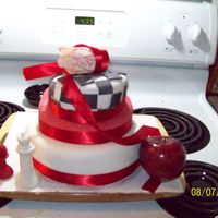 Twilight 3 tiered topsy turvy cake. All layers covered in fondant. Tulip is made of gum paste. Chess pieces and checker board made of fondant. real...