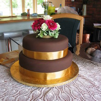 Two Tiered Round Wedding Cake Two tiered round wedding cake using chocolate fondant. Cake was two tiers of chocolate mud cake with chocolate buttercream. Bride supplied...