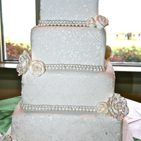 Elegant Wedding Cake This is a fondant cake with royal icing stencils. The design was then hand painted with silver/vodka luster dust.