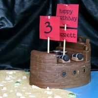 Pirate Ship Port Side Covered in strips of fondant with a roller to make it look like wood. A lot of fun to make!!