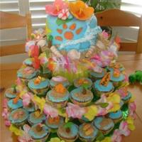 Hawaiian Cupcake Tower The top 6" cake is coconut/pineapple filling, all buttercream and gum paste flowers,the cupcakes are pina coladaand the decoration are...