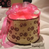 Gelatin Bow pink gelatin bow on a hummingbird (6in) cake with cream cheese icing