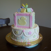 Baby Block 10" round, chocolate cake with chocolate filling; 6" square x 3 cinnamon vanilla cake with chocolate hazelnut filling. Frosted...