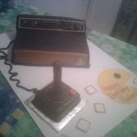 Atari And Joystick Chocolate cake, chocolate butter cream and fondant. Details piped with royal icing. This cake was lots of fun. Saw a picture on the net,...