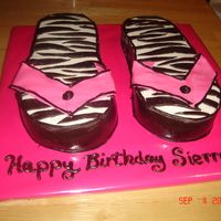 Zebra Striped Flip Flop Cakes cakes are cut to flip flop shape and covered in white buttercream. The zebra striped are dark chocolate fondant strips placed in zebra...