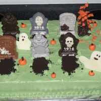 Halloween Graveyard Cake I made this for my son's 1st grade class. I used Wilton candy melts with the gravestone mold. I made the tree out of chow mein noodles...