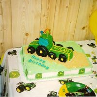 John Deere This is the first cake I have ever made, all buttercream using loaf pans to construct the tractor, dougnuts for the tires, and...
