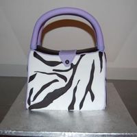 Zebra Purse Cake lemon cake, strawberry butter cream. Fondant cover, fondant/gumpaste handles