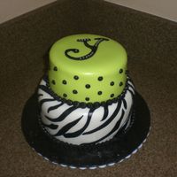 Lime Green Zebra Cake bottom tier is marble cake with choc. ganache filling, covered/accents in fondant. Top tier is white cake with lemon creme filling topped...