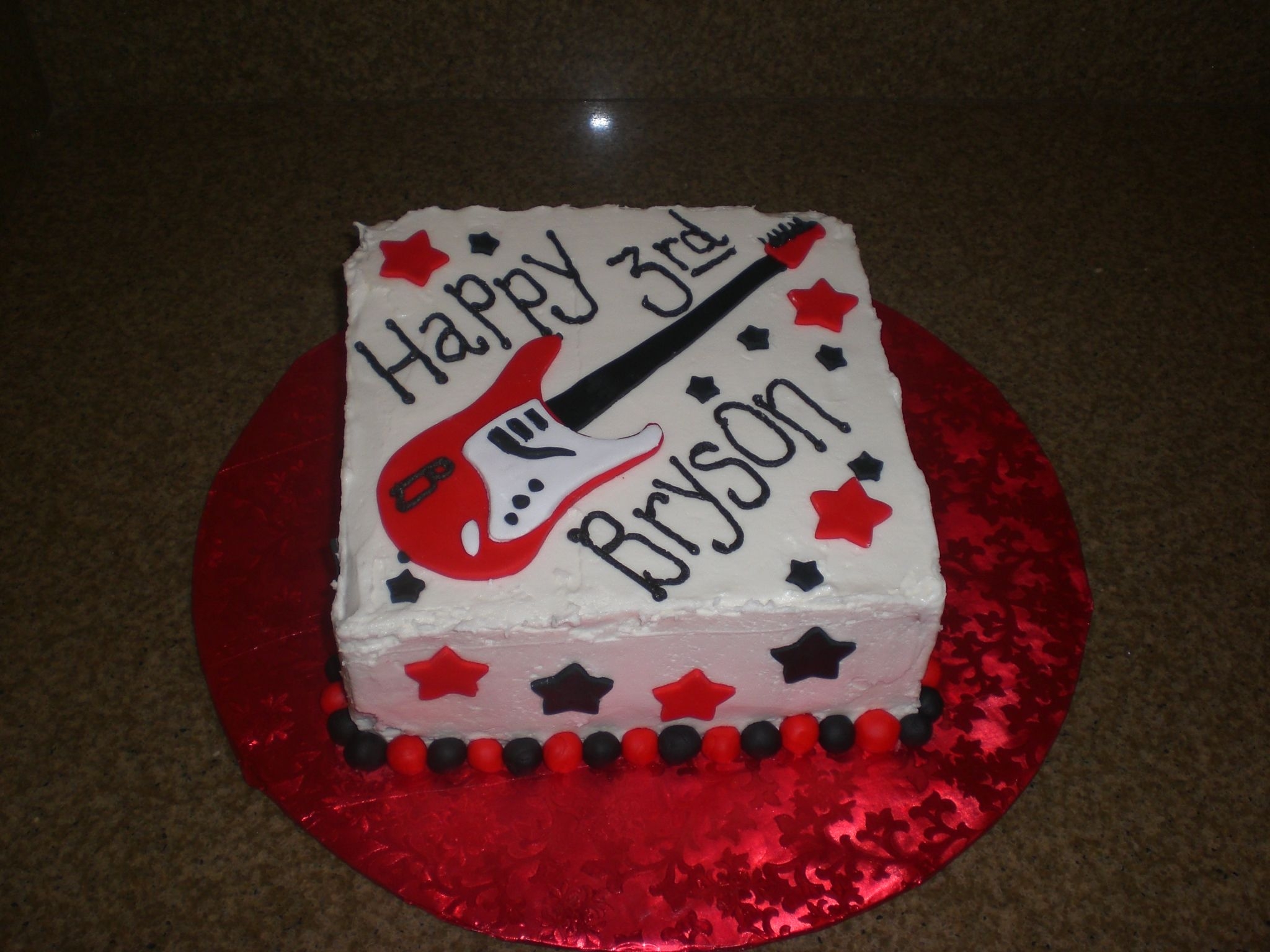 Rock Star Cake For a friend of my sons. 3rd bday, wanted a 'rock star' cake. Vanilla Choc chip with choc ganache filling. Decorators cream...