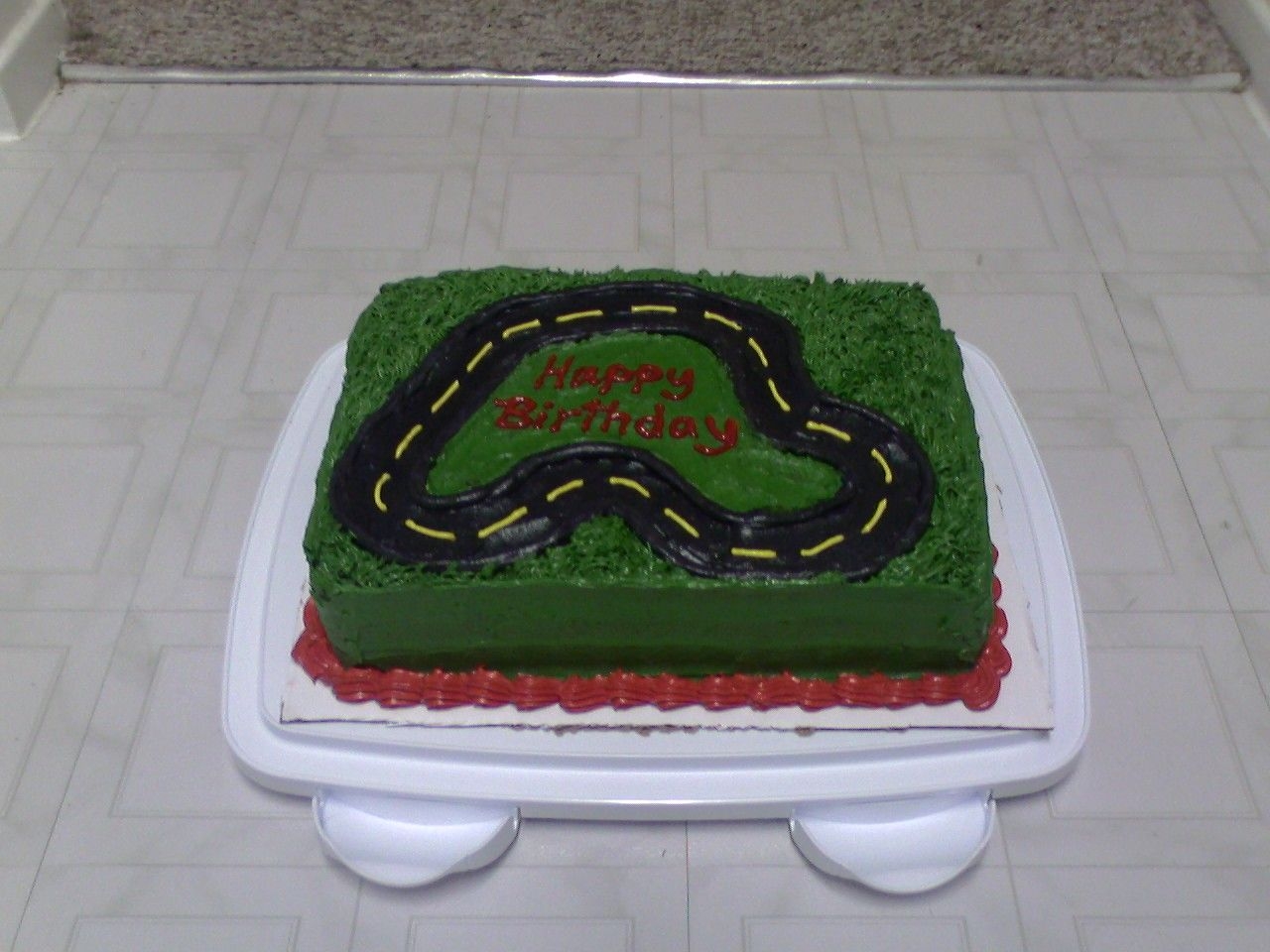 Racetrack Cake Not my favorite, I was in a hurry and the grass didn't turn out how I was picturing it, BC too soft. But it was fun :)