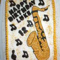Saxaphone This is a white cake with BC icing with edible glitter. I made the sax out of color flow and edible glitter.
