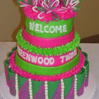 Two Peas In A Pod 3-tier cake; each layer different flavor; for two peas in a pod themed baby shower; bc icing; bows and curved panels out of white chocolate...
