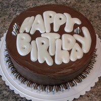 Chocolate Lovers Chocolate cake with chocolate icing; white chocolate letters with Hershey's Hugs border