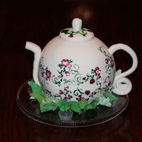 Tea Pot Tea Pot cake made from ball pan with fondant spout, handle & top. Pattern rubber stamped onto pot with food coloring.