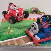 Red Racing Car And Thomas Tank Engine This was a cake made for two brother sharing the same birthday. One loved the TV character of "Roary the Racing Car" whilst the...