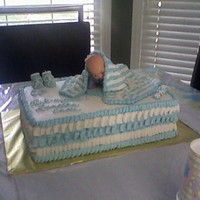 Baby Shower Cute rendition of a cake I saw on another site. Baby is on a board because it was not edible. Blanket is buttercream over plastic wrap. Mom...