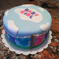 Baby Shower For Girl Entire cake is covered in fondant and accents.Made an outdoor clothes line with blue skies and clouds. With a few color changes it could...