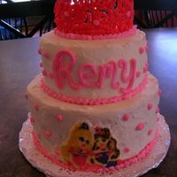 Barbie Princess Cake two tiers white buttercream, barbie buttercream transfer on bottom, royal icing tiara on top.