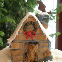 Little Log Cabin Cake layers of cake carved at top. covered in buttercream, then fondant in separate pieces "glued" on with royal icing and chimney...