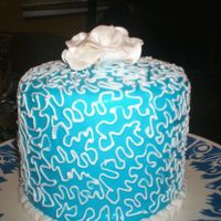 Birthday Cake rolled buttercream icing with cornelli lace, gumpaste rose with pearl dust.